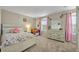 Cozy bedroom with carpet, dresser, and window, perfect for a or guest at 2727 Retriever Dr, Clermont, FL 34711