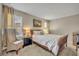 Bright bedroom features neutral tones, large window, and decorative starfish pillow for a cozy, beachy feel at 2727 Retriever Dr, Clermont, FL 34711