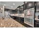 Well-appointed kitchen with a double oven, granite counters, and stainless appliances at 2727 Retriever Dr, Clermont, FL 34711
