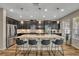 Bright kitchen with a granite island, stainless appliances, and dark cabinetry at 2727 Retriever Dr, Clermont, FL 34711