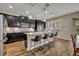 Kitchen island featuring granite countertops, pendant lighting, and seating for four at 2727 Retriever Dr, Clermont, FL 34711