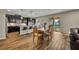 Modern kitchen with dark cabinetry, granite countertops, a center island, and an adjacent dining area at 2727 Retriever Dr, Clermont, FL 34711