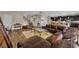 Open-concept living room with hardwood floors flowing into the kitchen and dining area, great for entertaining at 2727 Retriever Dr, Clermont, FL 34711