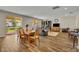 Open-concept floor plan with a dining table, living room, and backyard view at 2727 Retriever Dr, Clermont, FL 34711