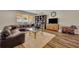 Spacious living room featuring a large sectional sofa, wooden floors, and a decorative bookshelf at 2727 Retriever Dr, Clermont, FL 34711