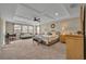Spacious main bedroom featuring a tray ceiling, ceiling fan, and large windows at 2727 Retriever Dr, Clermont, FL 34711