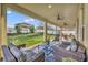 Spacious covered patio with comfortable seating, brick flooring, and a view of the fenced backyard at 2727 Retriever Dr, Clermont, FL 34711