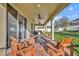 Covered outdoor patio with ceiling fans, brick flooring, and comfortable seating for relaxing and entertaining at 2727 Retriever Dr, Clermont, FL 34711