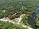 Stunning aerial view of a vast property nestled amidst lush greenery, showcasing a tranquil and private setting at 2886 N C 470, Lake Panasoffkee, FL 33538