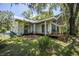 This home has a spacious wooden deck overlooking a serene backyard, perfect for entertaining at 2886 N C 470, Lake Panasoffkee, FL 33538
