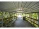 Covered wooden boardwalk features benches, lighting, and access to the water at 2886 N C 470, Lake Panasoffkee, FL 33538