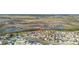 A beautiful aerial view of the neighborhood showcasing water views and neatly planned streetscapes at 303 Red Kite Dr, Groveland, FL 34736
