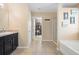 Bathroom featuring dark cabinets, granite countertops, and a walk-in closet at 303 Red Kite Dr, Groveland, FL 34736