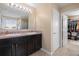 Bathroom with tiled floor and double vanity sinks at 303 Red Kite Dr, Groveland, FL 34736