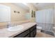 Bathroom with sink, granite countertop, mirror, toilet, and shower with gray and white curtain at 303 Red Kite Dr, Groveland, FL 34736