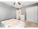 Bedroom with gray walls, carpet floors, walk-in closet, and white four-drawer dresser at 303 Red Kite Dr, Groveland, FL 34736