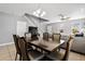Open concept living and dining areas featuring tile floors and a modern table with chairs at 303 Red Kite Dr, Groveland, FL 34736