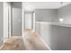 Second story hallway featuring gray walls, white trim, carpet floor, and entry doors at 303 Red Kite Dr, Groveland, FL 34736