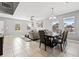 Spacious living and dining areas with tile flooring and a modern table with chairs at 303 Red Kite Dr, Groveland, FL 34736