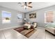 This living room features tile floors, ceiling fan, and natural light at 303 Red Kite Dr, Groveland, FL 34736