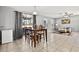 This living room features a table and chairs, tile floors, and beige sofa at 303 Red Kite Dr, Groveland, FL 34736