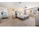Spacious main bedroom features a large bed, silver accents, natural light, and a ceiling fan at 303 Red Kite Dr, Groveland, FL 34736