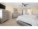 Bright main bedroom showcases a large bed, mirrored dressers, and carpeted floors for ultimate relaxation at 303 Red Kite Dr, Groveland, FL 34736