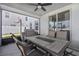 Inviting screened patio with comfortable seating and a ceiling fan, perfect for outdoor entertaining at 303 Red Kite Dr, Groveland, FL 34736