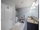 Bright bathroom featuring a granite vanity, separate dressing table, and glass-enclosed shower at 3339 Landing Vw, Tavares, FL 32778