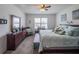 Comfortable bedroom with a large bed, dresser, and bright natural light from the window at 3339 Landing Vw, Tavares, FL 32778
