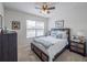 Bedroom with ceiling fan and decoratively framed artwork with a large window for natural lighting at 3339 Landing Vw, Tavares, FL 32778