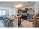 Modern kitchen with stainless steel appliances, dark cabinetry, and a granite countertop island at 3339 Landing Vw, Tavares, FL 32778