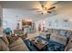 Open-concept living room with a cozy sofa, kitchen island and tile flooring at 3339 Landing Vw, Tavares, FL 32778