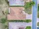 An aerial view of a charming home featuring a brick driveway, well-kept lawn, and a neatly designed roof at 33409 Pennbrooke Pkwy, Leesburg, FL 34748