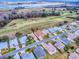 Aerial view of homes on a quiet street next to a golf course and lake at 33409 Pennbrooke Pkwy, Leesburg, FL 34748