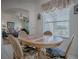 Cozy dining area features a round tile-top table and seating near a bright window with views at 33409 Pennbrooke Pkwy, Leesburg, FL 34748