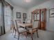 Traditional dining room featuring a wooden table, upholstered chairs, and a decorative display cabinet at 33409 Pennbrooke Pkwy, Leesburg, FL 34748