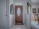 Foyer with decorative front door, tile flooring, high ceilings, and access to the dining room at 33409 Pennbrooke Pkwy, Leesburg, FL 34748