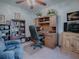 Home office boasts a large desk, bookcase, comfortable chair, and entertainment center at 33409 Pennbrooke Pkwy, Leesburg, FL 34748