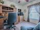 Bright office space with a large desk, chair, and a window with patterned curtains at 33409 Pennbrooke Pkwy, Leesburg, FL 34748