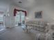 Bright living room featuring plush sofas, a glass table, and sliding doors leading to the outdoors at 33409 Pennbrooke Pkwy, Leesburg, FL 34748