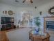 Spacious living room featuring a fireplace, large TV, and open access to the dining area at 33409 Pennbrooke Pkwy, Leesburg, FL 34748