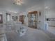 Bright living room with open layout to kitchen and dining area, display cabinet and plush furniture at 33409 Pennbrooke Pkwy, Leesburg, FL 34748