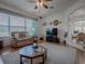 Inviting living room with plush sofa, decorative ceiling fan, and large window at 33409 Pennbrooke Pkwy, Leesburg, FL 34748