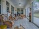 Enclosed sunroom featuring rattan furniture, tile flooring, and sliding glass doors offering outdoor views at 33409 Pennbrooke Pkwy, Leesburg, FL 34748