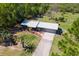 Aerial view of the single-story home featuring a gray metal roof and sprawling land at 37149 Grays Airport, Lady Lake, FL 32159