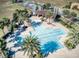 Aerial view of a cross-shaped community pool with palms and a picnic pavilion in a well-maintained neighborhood at 412 Arbor Pointe Ave, Minneola, FL 34715