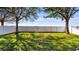 Spacious backyard with lush grass, mature trees, and a privacy fence at 412 Arbor Pointe Ave, Minneola, FL 34715
