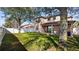 Spacious backyard with green grass, mature trees, and a white vinyl fence for privacy at 412 Arbor Pointe Ave, Minneola, FL 34715