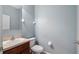 Half bath with vanity, toilet, and mirror at 412 Arbor Pointe Ave, Minneola, FL 34715